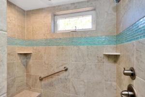 a bathroom with a shower with a window at Dolphin Daze by Pristine Properties Vacation Rentals in Saint Joe Beach +60 photos