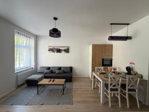 a living room with a couch and a table at Apartament between the bridges II in Zgorzelec