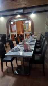 a long table in a restaurant with chairs around it at Parco Sogni d'Oro in Montella
