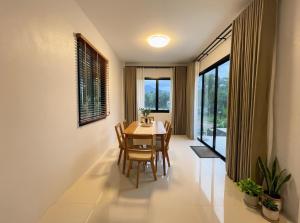 a dining room with a table and chairs and a window at Casa Phangan - Boutique Island Villa in Wok Tum