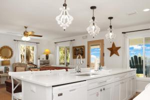 a kitchen with a sink and a living room at Latitude Adjustment by Pristine Properties Vacation Rentals in Indian Pass +49 photos
