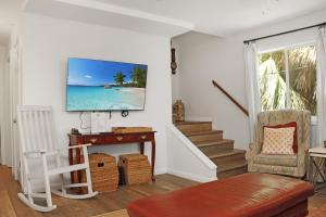 a living room with a tv on a wall at Latitude Adjustment by Pristine Properties Vacation Rentals in Indian Pass