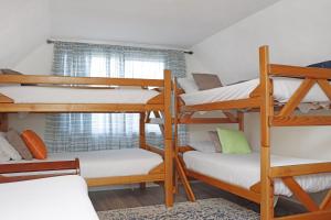 a room with four bunk beds and a window at Latitude Adjustment by Pristine Properties Vacation Rentals in Indian Pass
