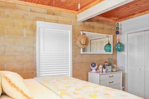 a bedroom with a bed and a brick wall at Quarters B by Pristine Properties in Mexico Beach