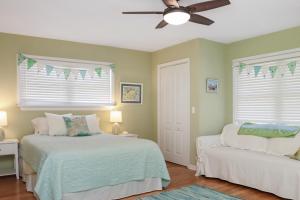 a bedroom with two beds and a ceiling fan at Summer Breeze by Pristine Properties Vacation Rentals in Indian Pass