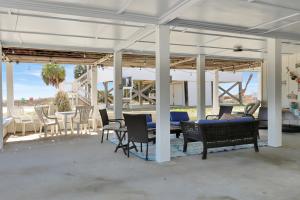 a pavilion with chairs and a table and a table and chairs at Summer Breeze by Pristine Properties Vacation Rentals in Indian Pass