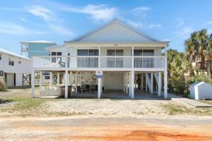a large white house with a large porch at Summer Breeze by Pristine Properties Vacation Rentals in Indian Pass