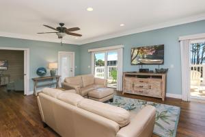 a living room with a couch and a tv at Treasure Road by Pristine Properties Vacation Rentals in Indian Pass