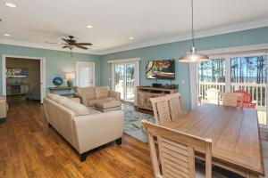a dining room and living room with a table and chairs at Treasure Road by Pristine Properties Vacation Rentals in Indian Pass