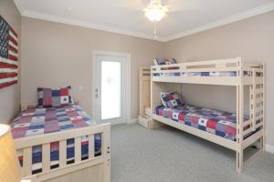 a bedroom with two bunk beds and a window at Treasure Road by Pristine Properties Vacation Rentals in Indian Pass +34 photos
