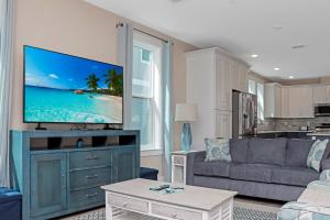 a living room with a flat screen tv on a dresser at Las Brisas By Pristine Property Vacation Rentals in Saint Joe Beach