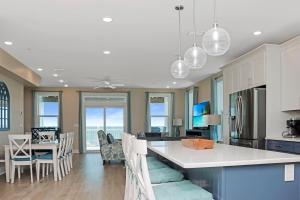 a kitchen and living room with a table and chairs at Las Brisas By Pristine Property Vacation Rentals in Saint Joe Beach