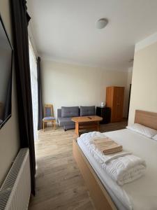 a bedroom with a bed and a living room with a couch at Rybitwa Karwia in Karwia