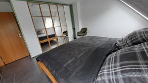 a bedroom with a bed and a sliding glass door at Nordmannsland I in Sudermarsch