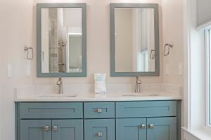 a bathroom with two sinks and two mirrors at Las Brisas By Pristine Property Vacation Rentals in Saint Joe Beach +58 photos
