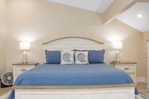 a bedroom with a bed with blue sheets and pillows at Las Brisas By Pristine Property Vacation Rentals in Saint Joe Beach