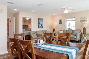 a dining room and living room with a table and chairs at Pelican Roost E by Pristine Properties Vacation Rentals in Mexico Beach