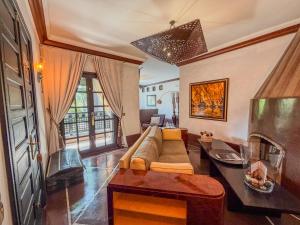 a living room with a couch and a fireplace at Villa Mano in Marrakesh +77 photos