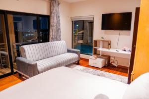a living room with a couch and a television at AB&AB Guesthouse Bedfordview in Germiston