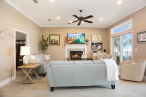 a living room with a white couch and a fireplace at Coastal Cove by Pristine Properties Vacation Rentals in Indian Pass