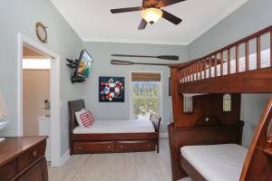 a bedroom with two bunk beds and a ceiling fan at Coastal Cove by Pristine Properties Vacation Rentals in Indian Pass +52 photos
