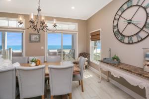 a dining room with a table and a large clock at Coastal Cove by Pristine Properties Vacation Rentals in Indian Pass