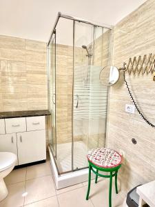 a bathroom with a shower and a stool at Casa della Nonna - Art & Vintage Rooms in Noicattaro +35 photos