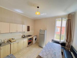 a kitchen with a refrigerator and a stove at Gulis Home in Shekhvetili +40 photos