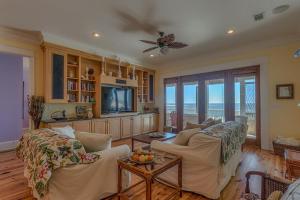 a living room with two couches and a tv at Island Idyl by Pristine Properties Vacation Rentals in Indian Pass