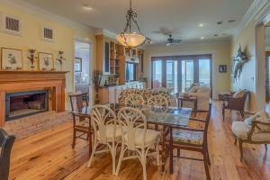 a living room with a dining table and a fireplace at Island Idyl by Pristine Properties Vacation Rentals in Indian Pass