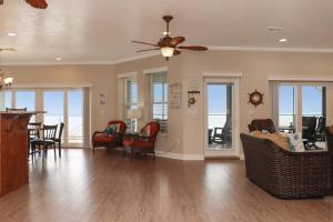 a living room with a ceiling fan and chairs at Farr Away Living by Pristine Properties Vacation Rentals in Indian Pass
