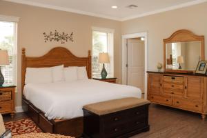 a bedroom with a large bed and a mirror at Farr Away Living by Pristine Properties Vacation Rentals in Indian Pass