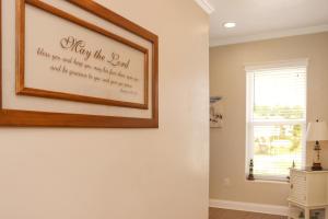 a living room with a picture on the wall at Farr Away Living by Pristine Properties Vacation Rentals in Indian Pass +69 photos