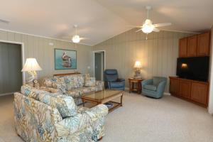a living room with couches and a flat screen tv at One More Time Again by Pristine Properties Vacation Rentals in Mexico Beach