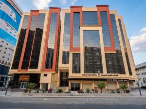 a large building with glass windows on a street at Alhijra View 2 - فندق الهجرة فيو 2 in Mecca