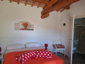 a bedroom with a bed with a red blanket at Masseria Spadone in Civitella Casanova