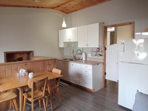 a kitchen with a table and a white refrigerator at Guest Suite in Smiths Falls