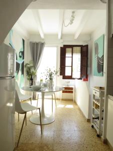 a kitchen with a table and chairs in a room at Casa al Castillo - charming & authentic townhouse - terrace with stunning castle views in Cullera