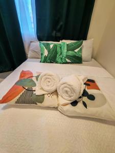 a bed with towels and pillows on it at Primeworld District Condo in Agus