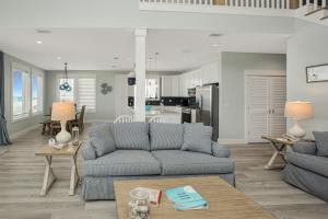 a living room with a couch and a table at Shore Looks Good by Pristine Properties Vacation Rentals in Mexico Beach