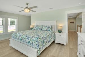 a bedroom with a bed and a ceiling fan at Shore Looks Good by Pristine Properties Vacation Rentals in Mexico Beach