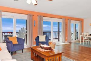 a living room with a couch and chairs and a table at Sun Chaser by Pristine Properties Vacation Rentals in Cape San Blas