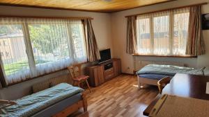 a bedroom with two beds and a table and chairs at B&B St Moritz in St. Moritz