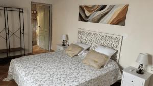 a bedroom with a white bed with two pillows at Masoala Forest in Piera