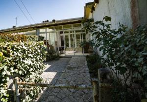 a house with a fence and a walkway next to a building at Les libellules in Andernos-les-Bains