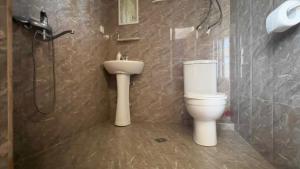 a bathroom with a toilet and a shower and a sink at Gulis Home in Shekhvetili