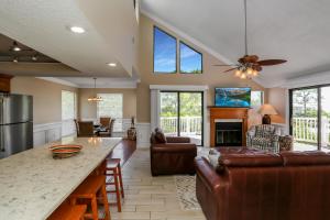 a living room with a couch and a table at A Swell Life by Pristine Properties Vacation Rentals in Cape San Blas