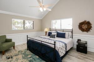 a bedroom with a bed and a ceiling fan at A Swell Life by Pristine Properties Vacation Rentals in Cape San Blas +48 photos