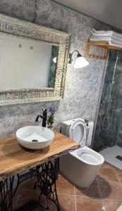 a bathroom with a sink and a toilet at Masoala Forest in Piera +45 photos