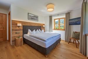 a bedroom with a large bed and a window at Chalet Menkenhof in Reit im Winkl